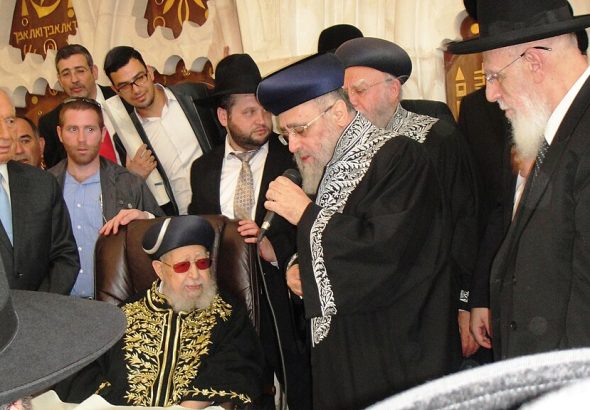 Coronation of Rabbi Yitzchak Yosef as Sephardi Chief Rabbi of Israel. Seen in picture: President Shimon Peres (far left), Rabbi Ovadia Yosef (seated), Rabbi Yitzchak Yosef (speaking into microphone), Rabbi Shalom Cohen (far right).